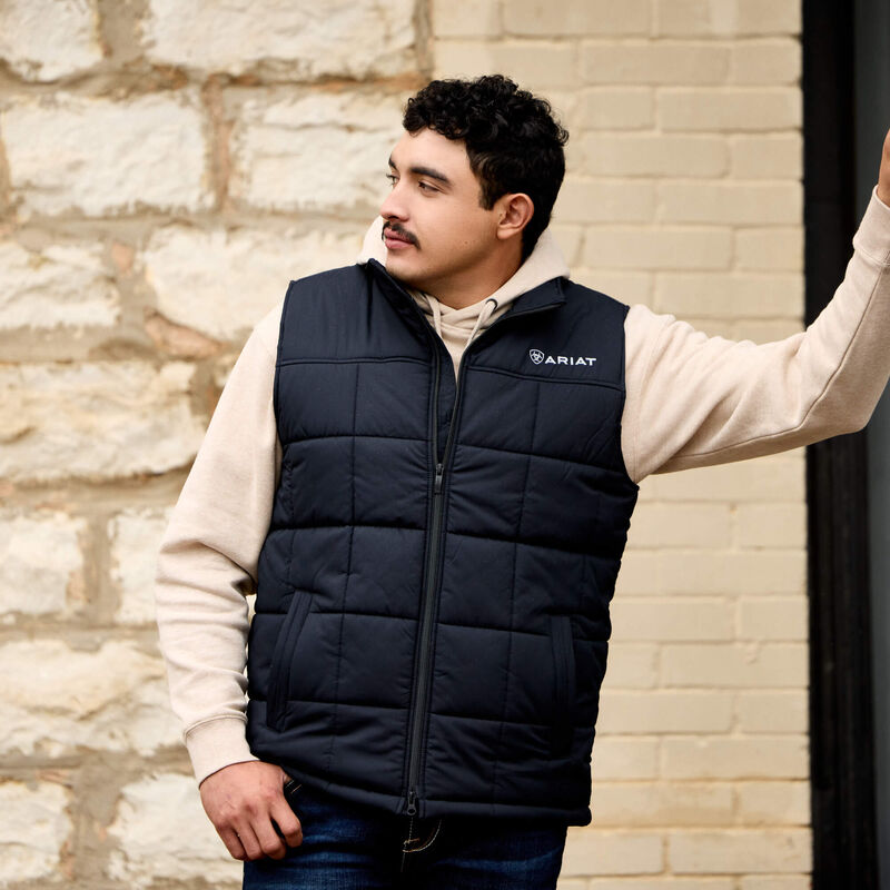 Ariat men's black Crius insulated vest, western men's wear, shown in a lifestyle setting with warm, durable fabric and functional design.
