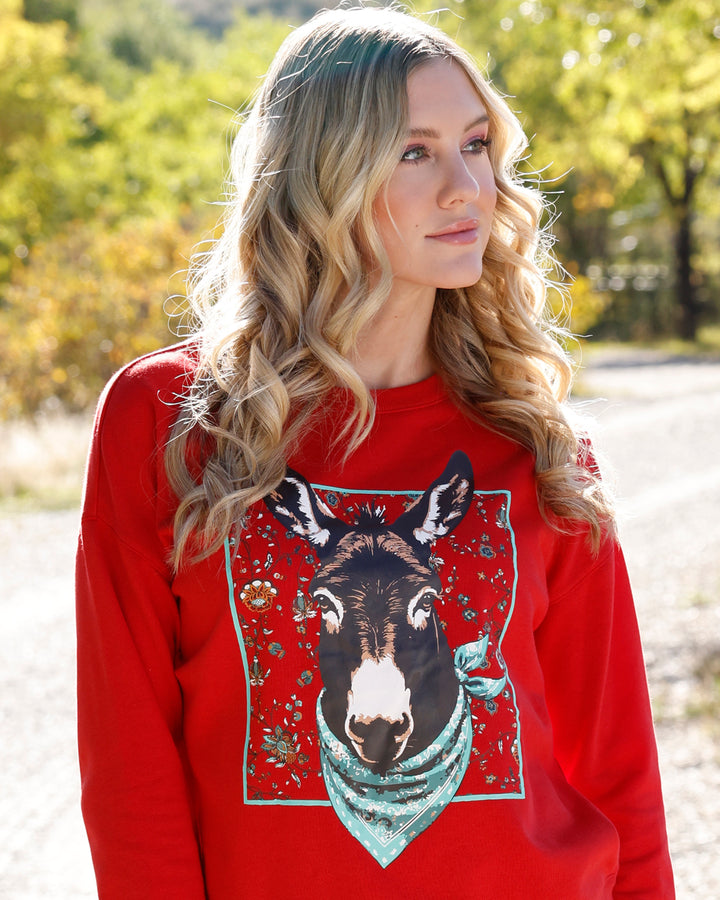 Red Cruel Women's Donkey Crewneck Sweatshirt featuring a western-inspired design, made from soft, comfortable fabric.