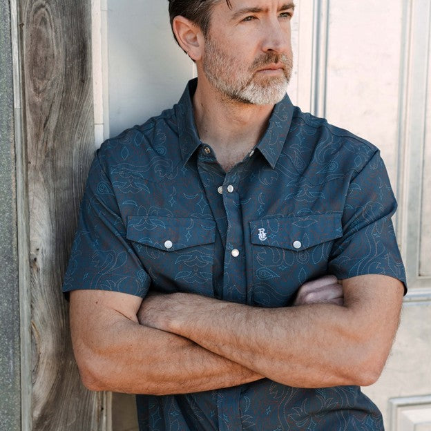 Raised By Coyotes Men's Cowboy Threads Pearl Snap Short Sleeve Shirt